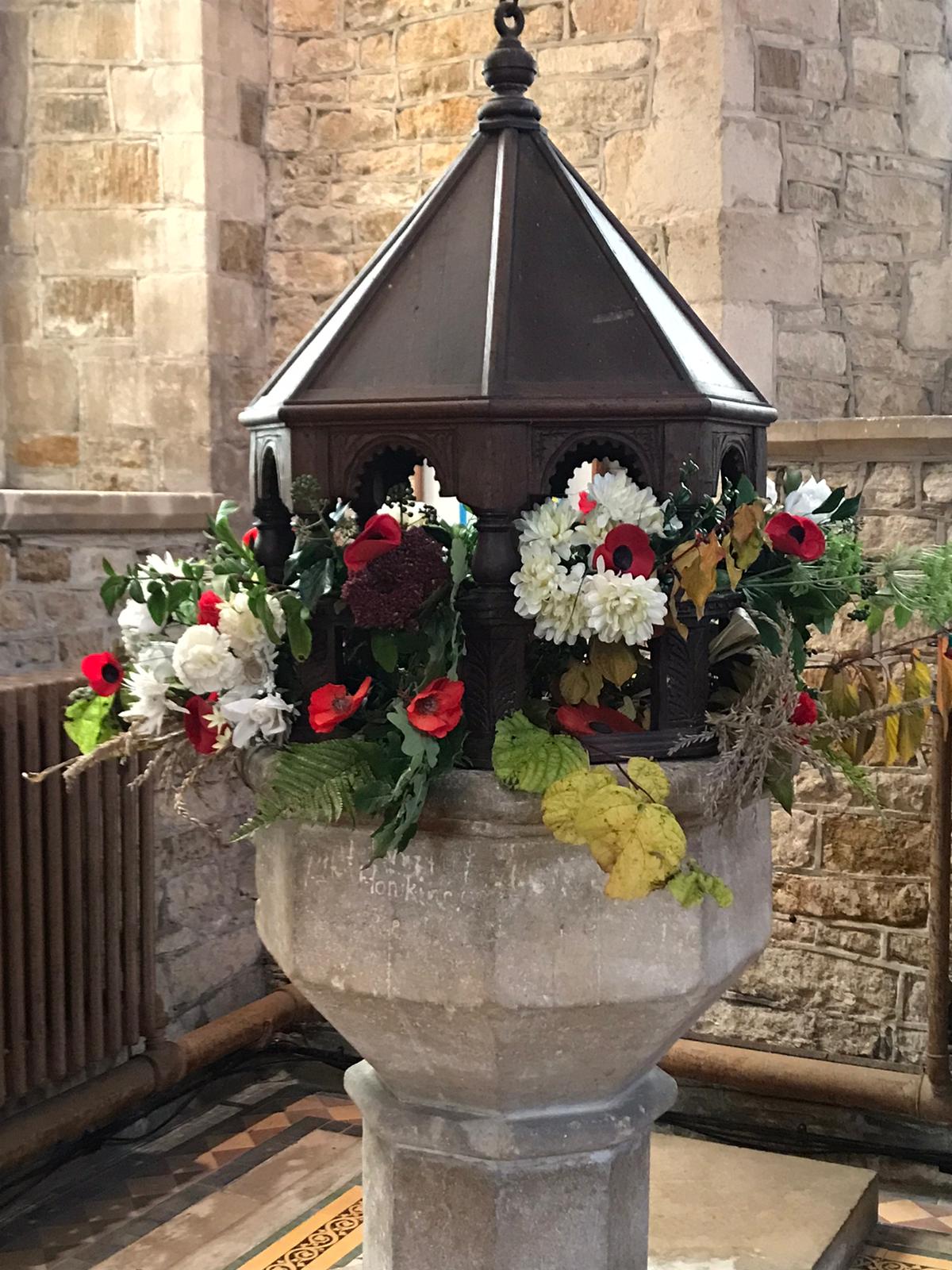 St Peter's Font - decorated in poppies for Remembrance